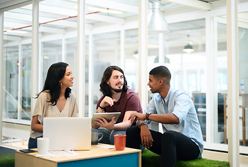 Image showing Working together to exceed the expectations of everyone. Shot of a group of businesspeople using a digital tablet together in an office.