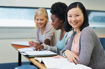 Image showing Her education is important to her. A group of students sitting in an exam room.