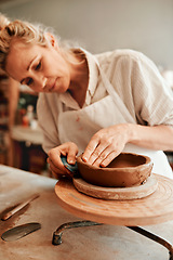 Image showing I love working with clay. Cropped shot of a woman shaping a clay pot in her workshop.