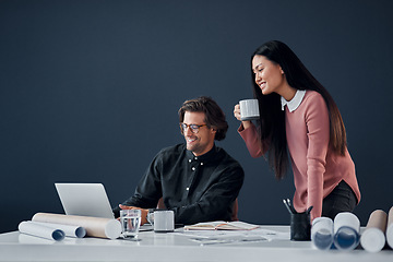 Image showing How do you like the look of that. Shot of two young architects going over designs on a laptop together in their office.