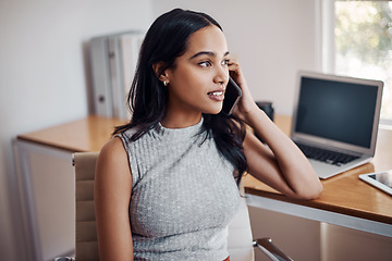 Image showing Success is calling her once again. Shot of a young businesswoman talking on a cellphone in an office.