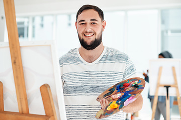 Image showing This good mood was sponsored by an art class. Cropped portrait of a handsome young artist standing alone and painting during an art class in the studio.