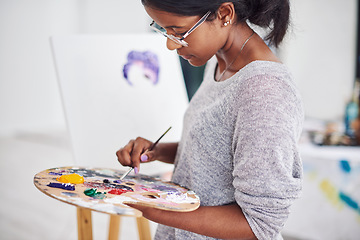 Image showing Something beautiful is about to come to life. Cropped shot of a beautiful young woman painting in a art studio.