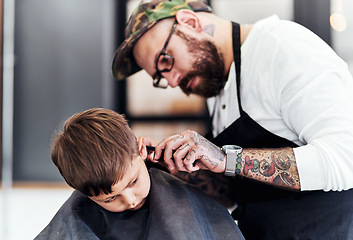 Image showing Just tilt your head a little. Cropped shot an adorable little boy getting a haircut at the barbershop.