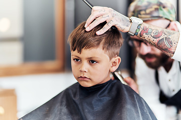 Image showing Youre never too you to start looking your best. Cropped shot an adorable little boy getting a haircut at the barbershop.