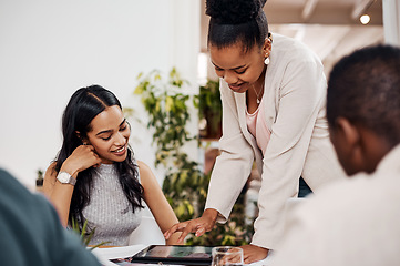 Image showing Reaching new levels of success with technology. Shot of two businesswomen working together on a digital tablet in an office.