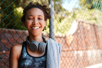 Image showing I enjoyed todays session. Portrait of a sporty young woman taking a break while standing against a fence outdoors.