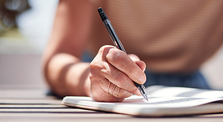 Image showing Hand, writing and book with a woman author sitting outdoor in summer for inspiration as a writer. Idea, planning and notebook with a female person using a pen to write in her journal or diary outside