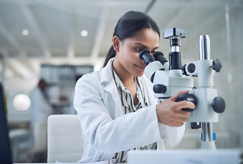 Image showing Science, microscope and innovation with a woman in a laboratory for medical research or experiment. Healthcare, medicine and a young indian engineer working in a lab for pharmaceutical development