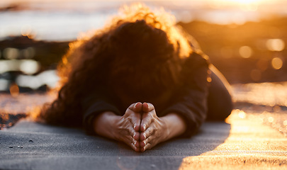 Image showing Woman, beach and sunset with yoga, balasana and stretching for health, fitness and mindfulness on holiday. Girl, workout and zen meditation for peace, mindset and nature with chakra balance by ocean