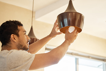 Image showing Repair, home and man change light bulb for maintenance, installation or building or property renovation. Handyman, ceiling lightbulb and male person with energy saving globe for illumination at house