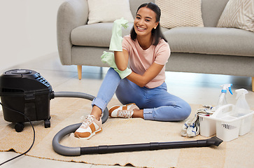 Image showing Vacuum, home and woman portrait with a smile from spring cleaning and tidy living room. Lounge, floor and young female person with happiness from clean rug, housekeeping and maid work on carpet