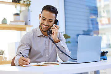 Image showing Consultant, businessman on telephone and writing in a notebook with a laptop at desk in office at his workplace. Networking or support, communication and man on a phone call for customer service