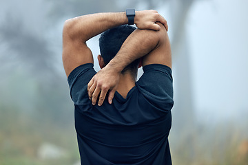 Image showing Fitness, back and man stretching arms for exercise, workout or training in the nature outdoors. Rear view of fit and active male person or runner in warm up stretch for running or cardio exercising