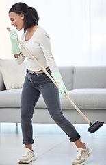 Image showing Singing, dance and woman with broom at home for cleaning, hygiene and weekend routine. Music, sing and female person having fun while sweeping a living room floor, happy and enjoying radio in a house