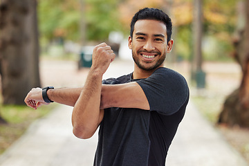 Image showing Happy asian man, portrait and stretching arms in fitness getting ready for running, workout or exercise at the park. Male person or runner with smile in warm up arm stretch, training or run in nature