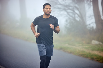 Image showing Man, fitness and running on road in nature for cardio workout, exercise or training outdoors. Fit, active or athlete male person or runner exercising on street asphalt in run for healthy wellness