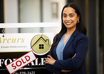 Image showing Sold, real estate and woman in portrait with arms crossed for home investment, property sale and agency. Happy face of agent, realtor or biracial person with house sign or board in business success