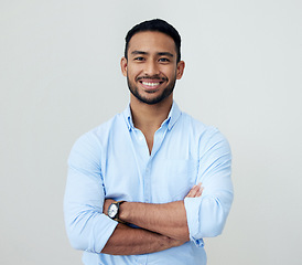 Image showing Economist, portrait and business man with arms crossed in studio isolated on a white background. Face, confidence and happy Asian male professional, entrepreneur or analyst from Singapore with mockup