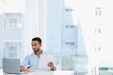 Image showing Laptop, documents and business man analyst working on project in office workplace. Computer, paperwork and serious male professional analyze report for finance, planning strategy or typing email.