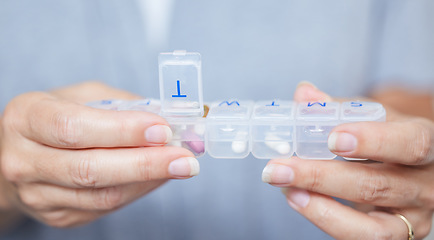 Image showing Hands, container and routine healthcare with a woman in her home during retirement closeup for daily vitamins. Medicine, medical and supplements with an elderly person taking prescription medication