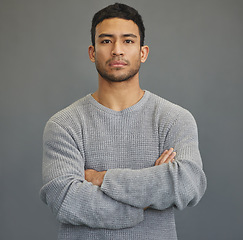 Image showing Serious, arms crossed and portrait of man in studio for attitude, moody and focus. Stress, sad and problem with face of male model on grey background for mental health, sadness and disappointed