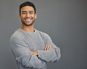 Image showing Portrait of happy man in studio with mockup, arms crossed and smile on studio backdrop in casual fashion. Relax, confidence and face of male on grey background with happiness and pride with space.