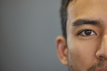 Image showing Mockup, portrait and half eyes of a man isolated on a grey background in studio. Serious, Asian and closeup face of a person with space for expression, looking handsome and a young eye on a backdrop