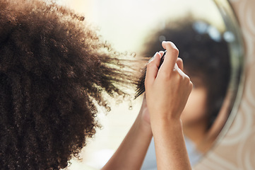 Image showing Hair care, woman with afro and comb in mirror for bathroom routine, beauty and morning grooming in home. Haircare, reflection and African model brushing curls from the back, combing curly hairstyle.