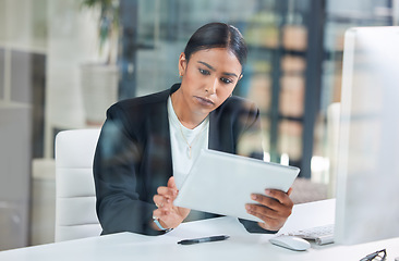 Image showing Business woman, tablet and typing in a office with web designer working on ui information. Internet research, young female worker and thinking of a employee on a app for digital project and work