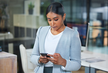 Image showing Phone, corporate and business woman typing an email or search the internet, web and website in an office. Smartphone, online and employee or person on social media to connect or network on mobile app