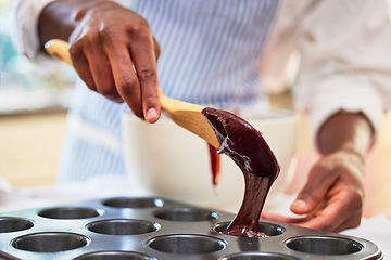 Image showing Cupcake, chocolate and hands of a person baking in a kitchen and cooking dessert recipe in the morning. Restaurant, man and professional chef preparing to bake in a muffin or culinary tray at bakery