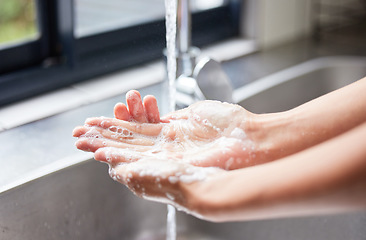 Image showing Water, tap and person washing hands with soap for skincare, healthy dermatology and bacteria safety at home. Closeup, basin and cleaning hand with foam for hygiene routine, wellness and protection