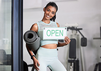 Image showing Happy woman, portrait or personal trainer at gym with an open sign for workout exercises or training. Friendly manager, fitness business or healthy girl with a smile holding a board or welcome poster