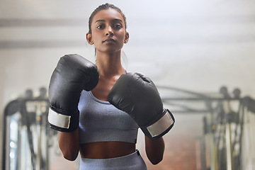 Image showing Fitness, gym or portrait of girl boxer in training, exercise or workout with a warrior mindset or wellness. Sports, motivation or healthy woman with speed, fast or powerful punch in boxing gloves