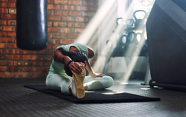 Image showing Gym, fitness or flexible woman stretching legs for a workout or body movement for wellness. Warm up, active athlete or healthy girl relaxing her spine in exercise training for flexibility or mobility