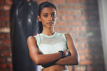 Image showing Woman, fitness and serious face in portrait with athlete in gym, arms crossed and determination with confidence. Mockup space, female person in exercise studio and active with health, sport and tough