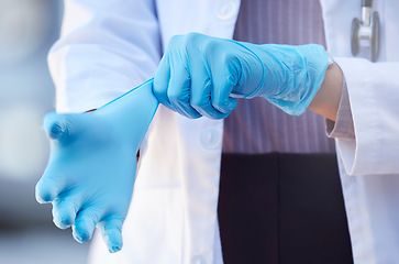 Image showing Healthcare, hand of doctor and surgery with surgical gloves for protection at a hospital. Procedure or ppe, health and hands of a nurse or surgeon to perform an operation at a medical clinic
