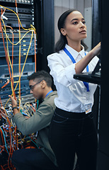 Image showing Server room, engineer or IT team working together for programming, cybersecurity or maintenance. African woman and man technician in datacenter for network, software and server or system upgrade