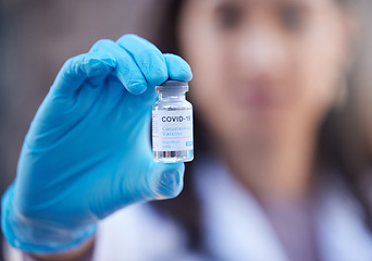 Image showing Doctor, covid vaccine and medicine in hand for corona virus in a hospital lab for healthcare and healing. Woman or medical worker with bottle of liquid or pharmaceutical product for safety and health