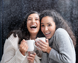 Image showing Women, friends and snowfall with coffee, laugh and happiness together on holiday with warm drink. Snow, girl or woman in winter with laughing, love and happy with matcha, espresso or latte outdoor