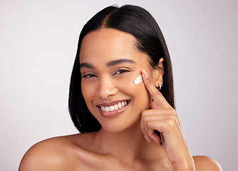 Image showing Happy woman, portrait and face cream for skincare, beauty or cosmetics against a grey studio background. Female person or model smiling for lotion, creme or cosmetic moisturizer or facial treatment