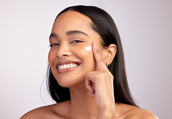Image showing Happy woman, portrait and skincare cream on face for beauty or cosmetics against a grey studio background. Female person or model smiling for lotion, creme or cosmetic moisturizer or facial treatment