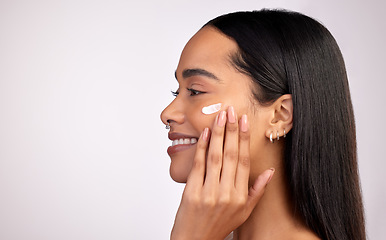 Image showing Happy woman, face and cream on mockup for skincare, beauty or cosmetics against a grey studio background. Female person smiling with lotion, creme or moisturizer for facial treatment on mock up space