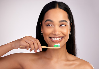 Image showing Happy woman, toothbrush and teeth for dental, cleaning or hygiene against a grey studio background. Face of female person with bamboo tooth brush for clean oral, mouth and gum healthcare or wellness