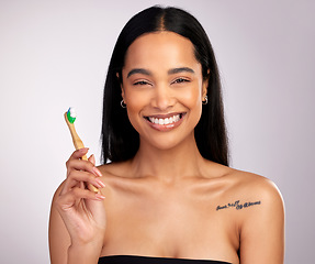 Image showing Happy woman, portrait and teeth with toothbrush for dental, cleaning or hygiene against a grey studio background. Face of female person with bamboo tooth brush in clean oral, mouth and gum healthcare