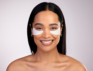 Image showing Happy woman, portrait and eye patches for skincare, collagen or dermatology against a grey studio background. Face of female person or model smiling for beauty cosmetics, mask or facial treatment