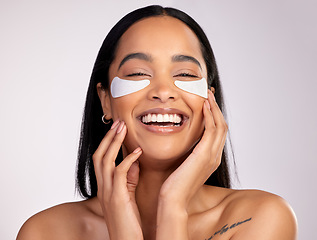 Image showing Happy woman, portrait smile and eye mask in skincare, collagen or dermatology against a grey studio background. Face of female person or model smiling in beauty cosmetics, patches or facial treatment