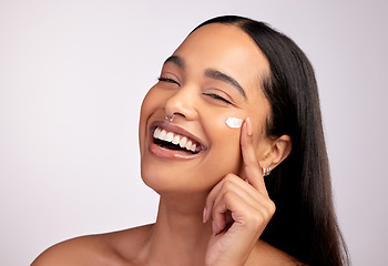 Image showing Happy woman, portrait and skincare cream, product or beauty cosmetics on face against a grey studio background. Female person or model smiling with lotion, creme or moisturizer for facial treatment