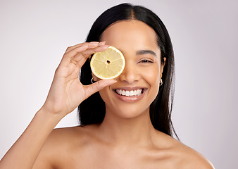 Image showing Happy woman, portrait and lemon for natural vitamin C, citrus or healthy nutrition against a grey studio background. Face of female person with fruit in skincare, collagen or antioxidant for diet